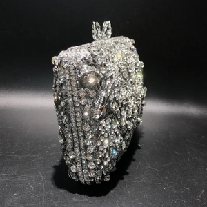 Macro shot of silver crystal evening bag showing intricate rhinestones and rabbit ear clasp