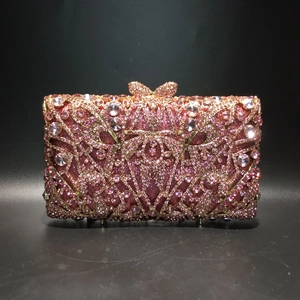 Detail of pink crystal evening bag featuring hollow metalwork and a bow clasp