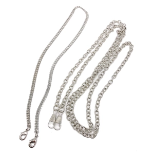 Detail of silver Cuban and O-link metal chains with spring hooks for evening handbags
