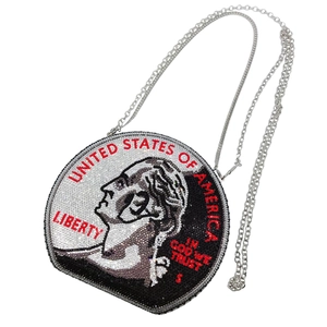 Close-up of sparkling rhinestone dollar coin evening bag with fine silver chain strap