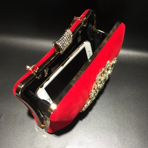 Close-up of red velvet evening clutch interior showing space for a smartphone