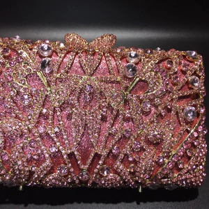 Macro shot of pink rhinestones and crystal flower patterns on luxury evening clutch