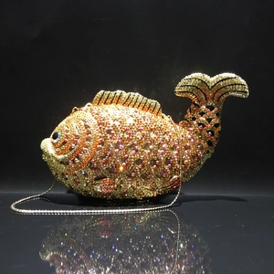 Detailed view of goldfish evening bag featuring intricate crystal scales and gold metal frame