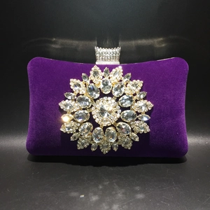 Purple velvet evening clutch bag featuring a large sparkling crystal floral motif on front