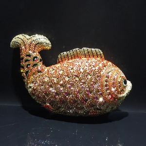 Detailed close-up of fish-shaped evening clutch with sparkling colorful rhinestones