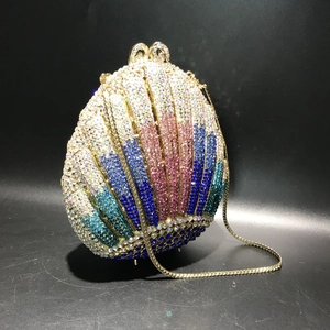Detailed view of the shell-shaped evening clutch bag with gradient crystal rhinestones