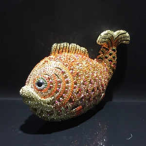 Detailed close-up of a goldfish-shaped evening clutch bag with colorful rhinestones