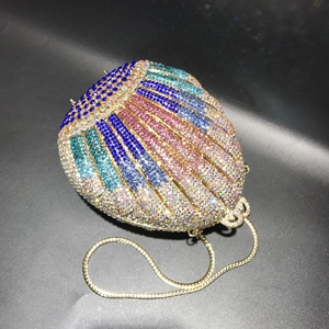 Detailed macro view of colorful gradient crystal rhinestones on a shell-shaped clutch bag