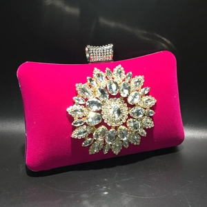Elegant fuchsia velvet clutch bag featuring a sparkling sunflower rhinestone ornament