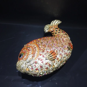 Detailed close-up of fish-shaped evening clutch with handcrafted crystal rhinestones