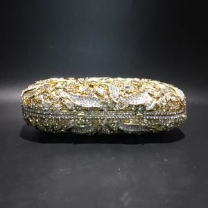 Detailed macro of crystal-encrusted evening clutch bag with intricate floral patterns