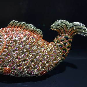 Macro view of fish-shaped evening bag with colorful hand-set rhinestones and hollow details