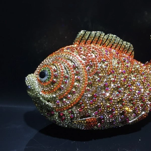 Macro shot of colorful rhinestones on a fish-shaped evening clutch bag