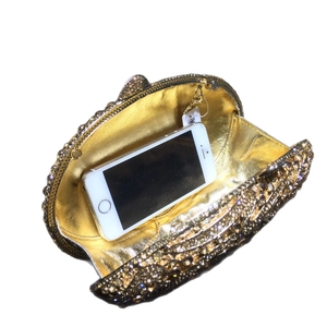 Champagne gold crystal clutch bag with rhinestones showing phone storage capacity