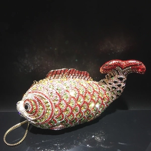 Detailed macro of crystal fish evening clutch with intricate colorful rhinestone scaling