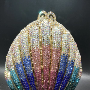Close-up of shell-shaped luxury evening bag with gradient rhinestones and gold clasp