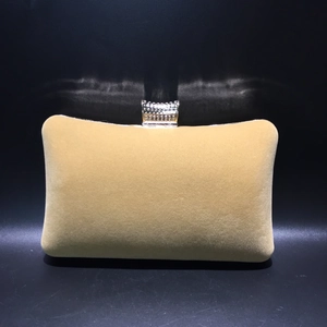 Macro shot of khaki velvet evening bag featuring crystal-studded rectangular metal clasp