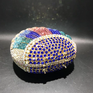 Detailed top view of a shell-shaped evening clutch with multi-color radiating crystals
