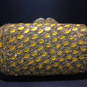 Luxurious gold evening clutch bag with yellow cat-eye stones and crystal rhinestones