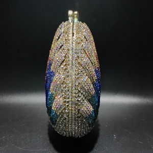 Macro detail of leaf-patterned crystal evening bag with vibrant gradient rhinestones