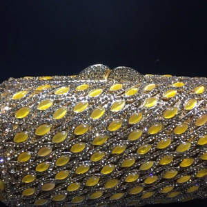 Detailed macro view of gold evening clutch with yellow marquise stones and sparkling rhinestones