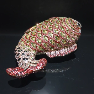 Detailed close-up of fish-shaped evening clutch with colorful rhinestones and fine scales