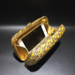 Detail of gold crystal evening clutch bag showing spacious interior for a smartphone