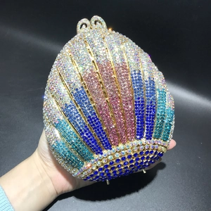 Detailed close-up of a shell-shaped evening bag featuring multi-colored hand-set crystals