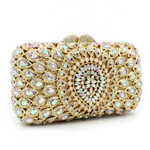 Detailed close-up of golden hollow evening bag with colorful rhinestone peacock pattern