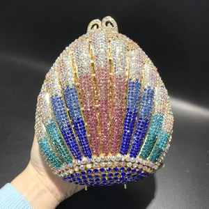 Detail of shell-shaped evening bag with gradient crystal rhinestones and gold clasp