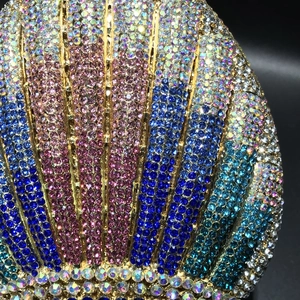 Detailed view of luxury shell-shaped evening bag featuring gradient colorful rhinestones
