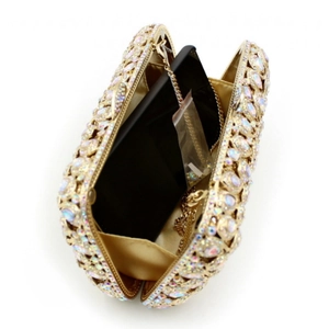 Internal view of gold hollow rhinestone evening clutch with chain and phone for scale