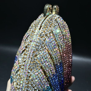 Macro view of shell-shaped evening clutch bag with colorful gradient rhinestones