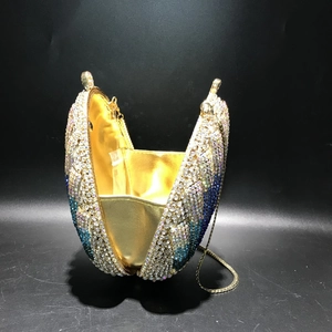 Macro view of blue gradient crystal evening clutch with metallic lining and gold chain