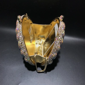 Macro view of crystal evening bag interior showing gold lining and phone capacity