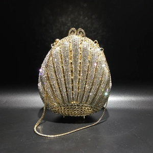 Detail of crystal shell evening clutch showing gold hardware and sparkly rhinestones