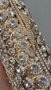 Macro shot of luxury evening clutch with sparkling crystals and pearl embellishments