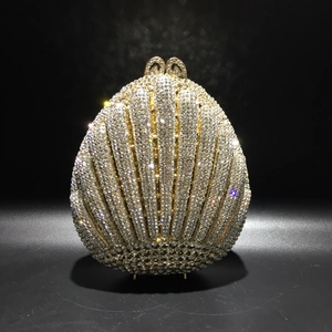 Close-up of shell-shaped evening clutch bag with dense sparkling crystal rhinestones