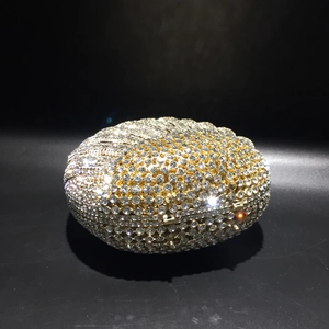 Detailed close-up of shell-shaped evening clutch bag with sparkling inlaid crystals
