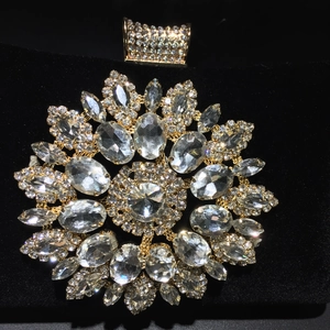 Macro detail of sunflower rhinestone crystal embellishment on black velvet evening bag
