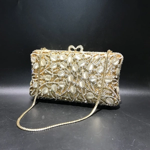 Golden evening clutch bag with sparkling crystals and white cat-eye stones for formal events