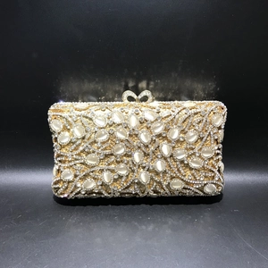 Luxurious gold hollow metal evening clutch with crystals and cat-eye stones