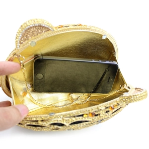 Interior view of the golden tiger head clutch showing capacity for a smartphone