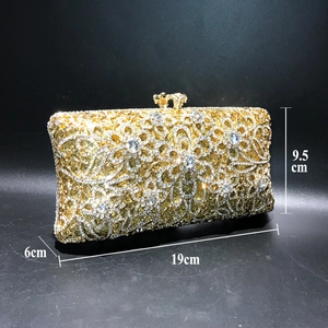 Detailed view of hollow gold floral clutch size 19cm by 9.5cm with sparkling crystals