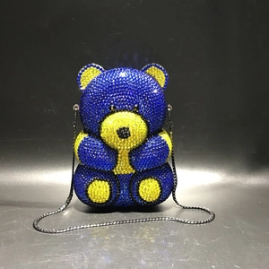 Detail view of bear-shaped evening clutch featuring blue and yellow crystal rhinestones