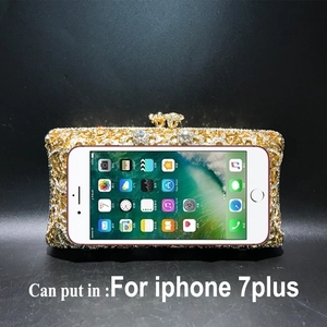Golden rhinestone evening bag compared with iPhone to show internal capacity
