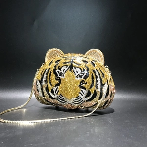 Close-up of tiger head evening bag with crystal rhinestones and gold chain strap