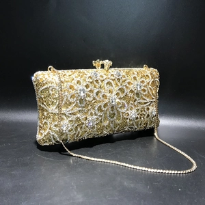 Detailed shot of golden hollow floral evening bag with sparkling crystal rhinestones