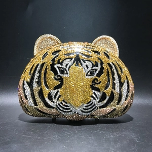 Macro shot of tiger head evening bag with detailed golden and black crystals