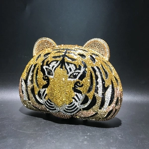 Detailed view of handcrafted tiger head evening clutch bag with sparkling crystal rhinestones